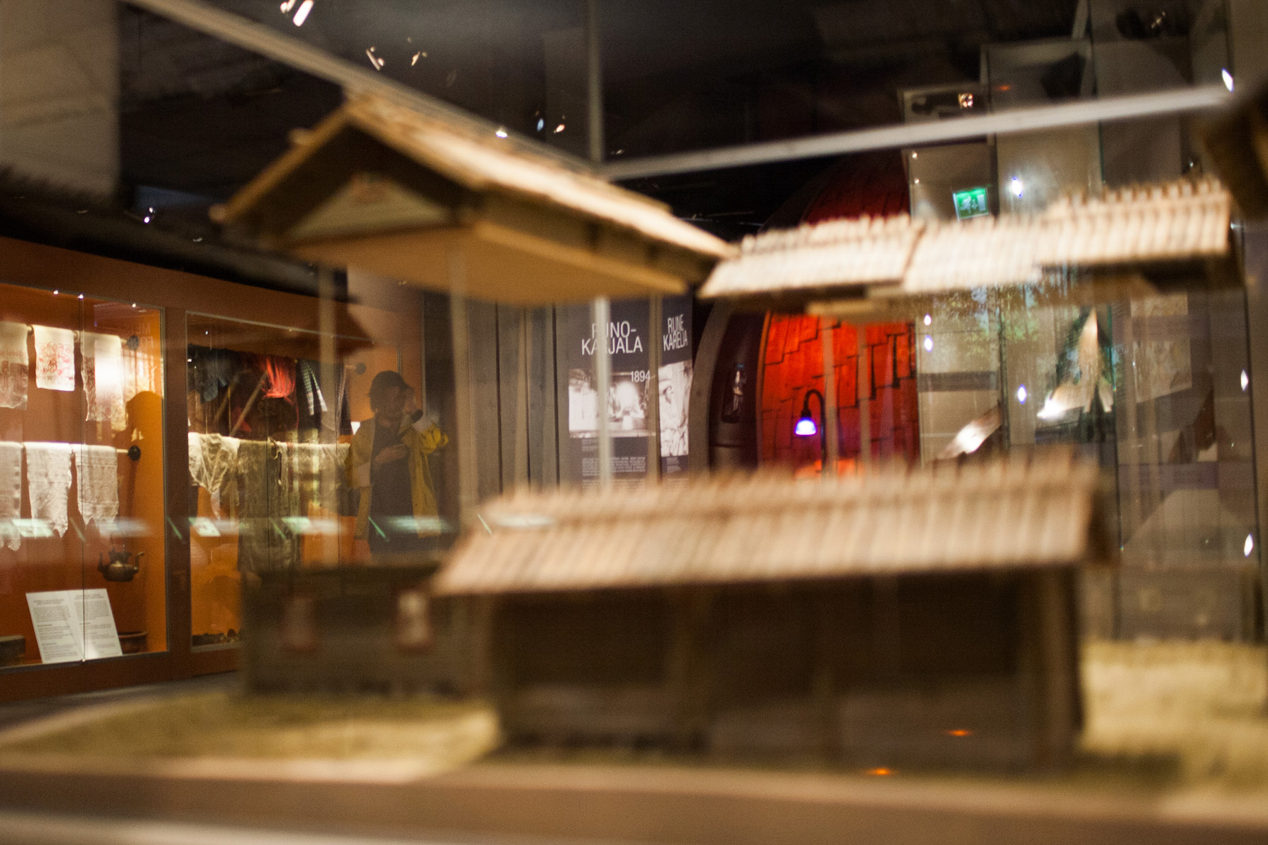 Pohjois-Karjalan museon näyttelytila, jossa kansallispukuja sekä pienoismalleja bomban pihasta